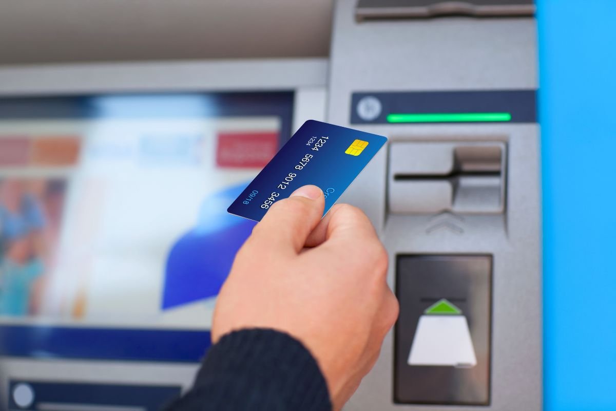 Person-holding-ATM-card-in-hand